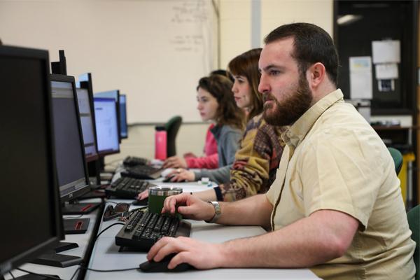 Row of students using computers.